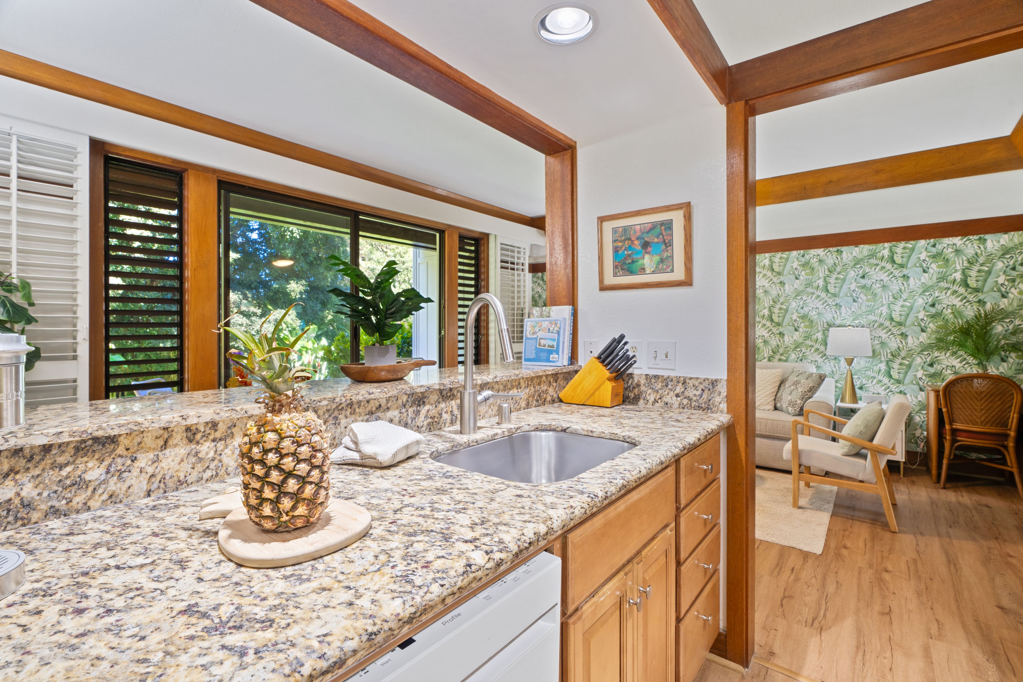 2253 Poipu Road, Unit 419 Koloa, HI 96756 - Photo 2 of 30 a kitchen with a granite countertop sink and a large window