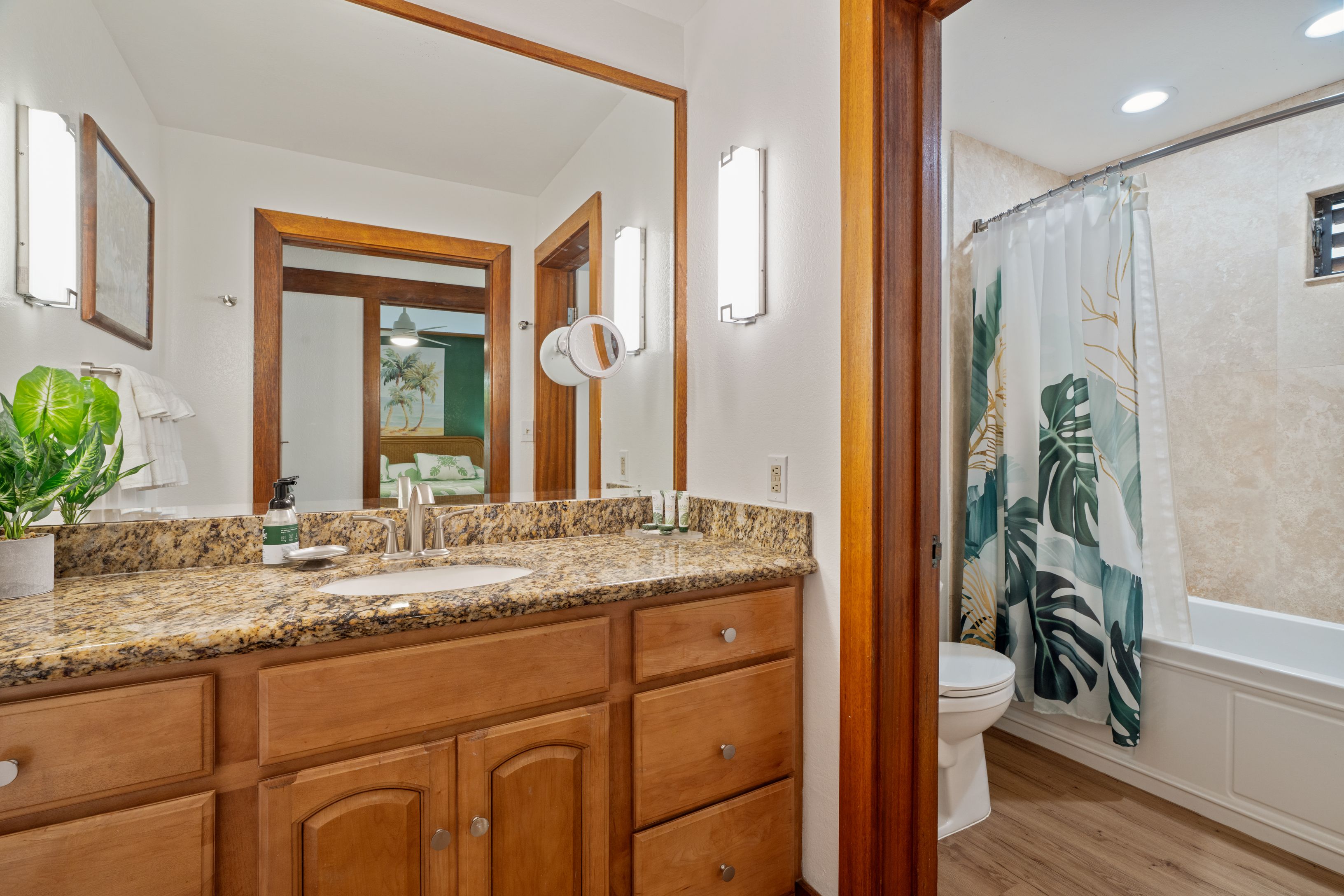 2253 Poipu Road, Unit 419 Koloa, HI 96756 - Photo 23 of 30 a bathroom with a granite countertop sink a mirror a vanity and a shower