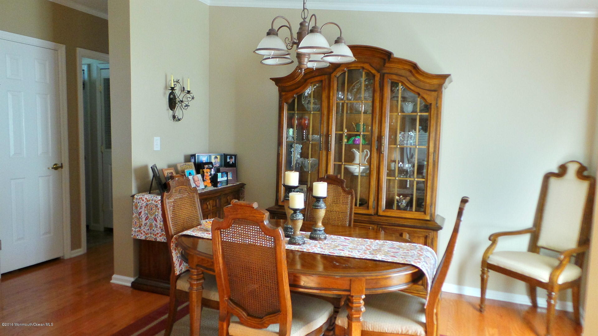 86 Village Road, Unit 86 Morganville, NJ 07751 - Photo 10 of 22 a view of a dining room with furniture and chandelier