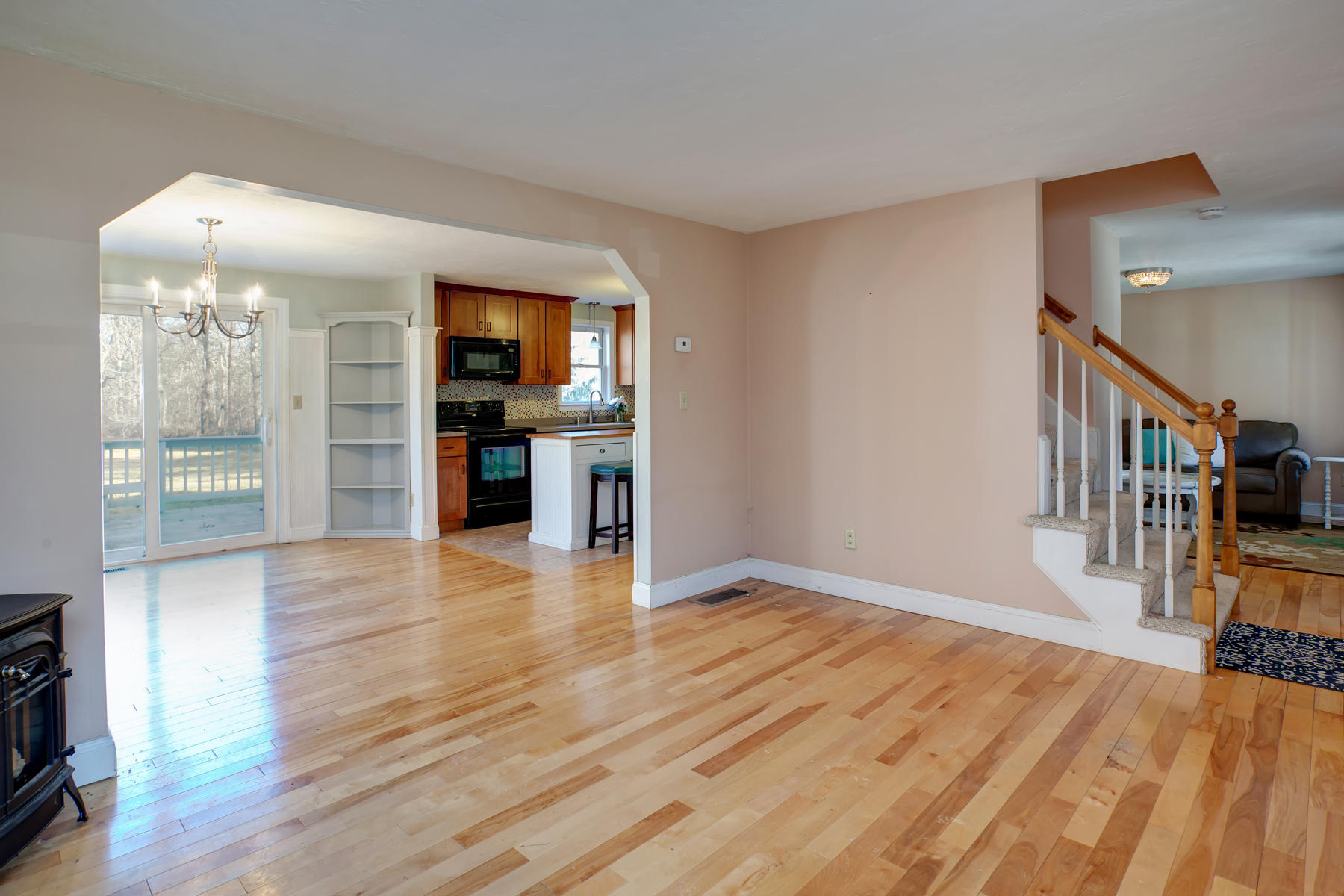 178 Farmersville Road Sandwich, MA 02563 - Photo 4 of 25 a view of a livingroom with wooden floor and fireplace