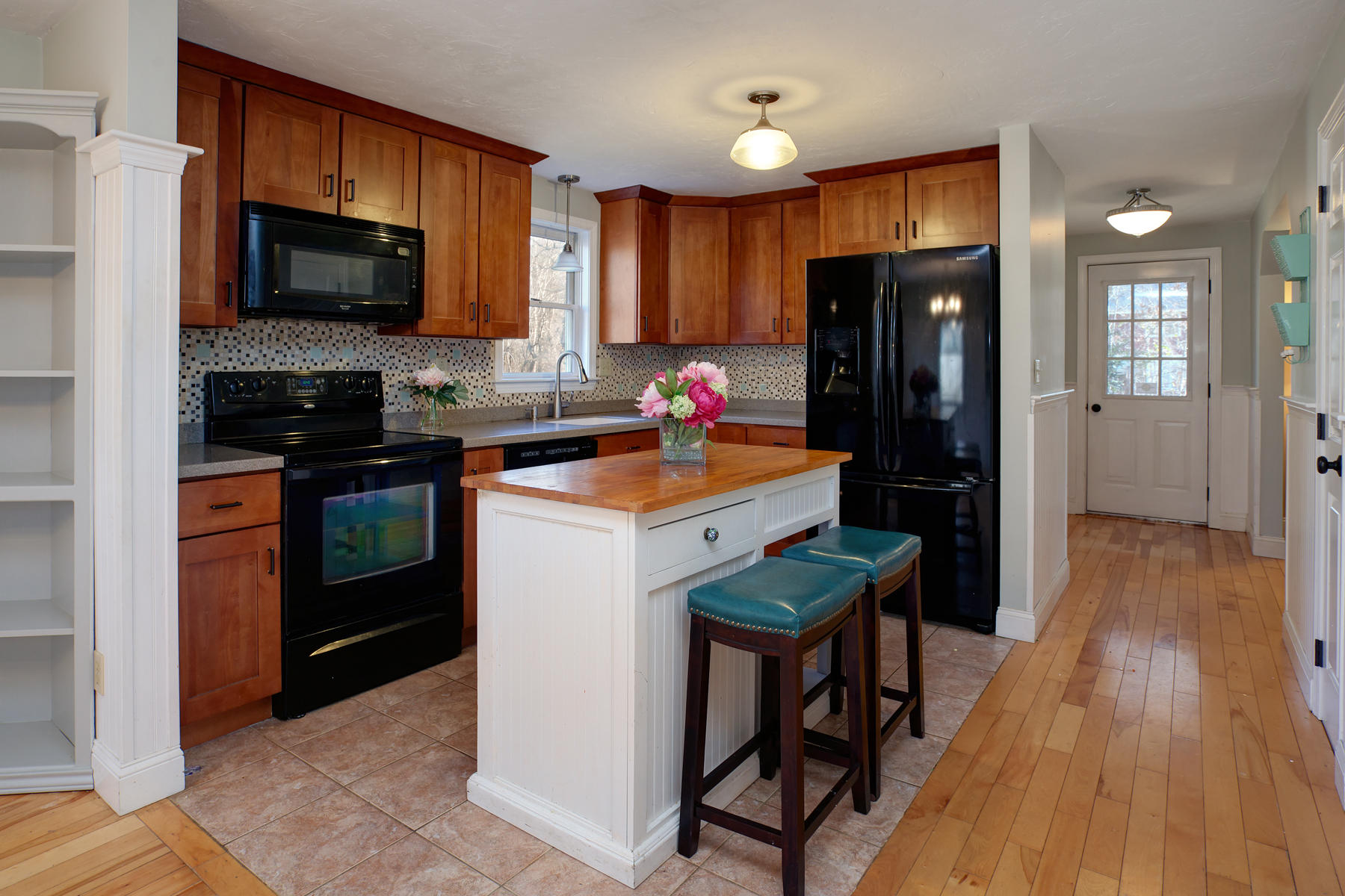 178 Farmersville Road Sandwich, MA 02563 - Photo 8 of 25 a kitchen with a sink a microwave a refrigerator and cabinets
