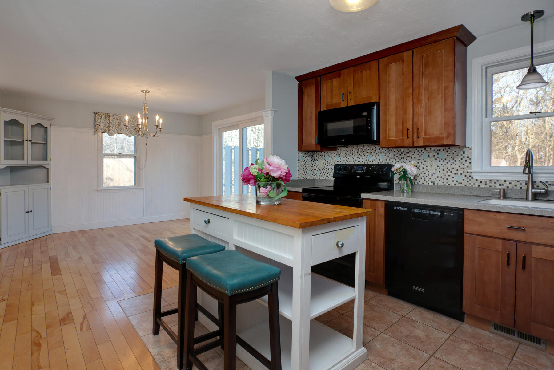 178 Farmersville Road Sandwich, MA 02563 - Photo 10 of 25 a kitchen with a wooden floor and cabinets