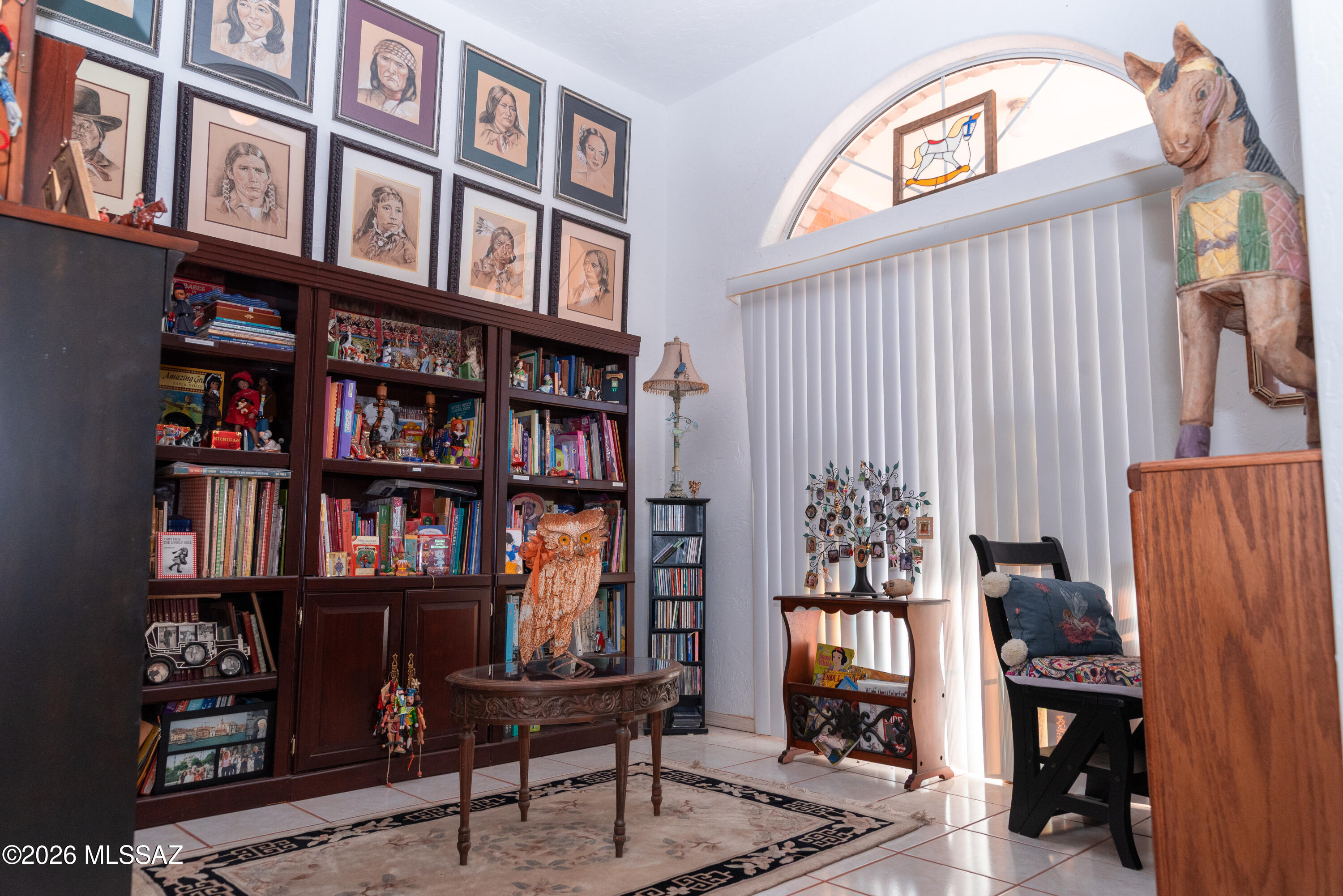 1242 Vista Court Rio Rico, AZ 85648 - Photo 10 of 16 a view of a workspace with bookshelf and a window
