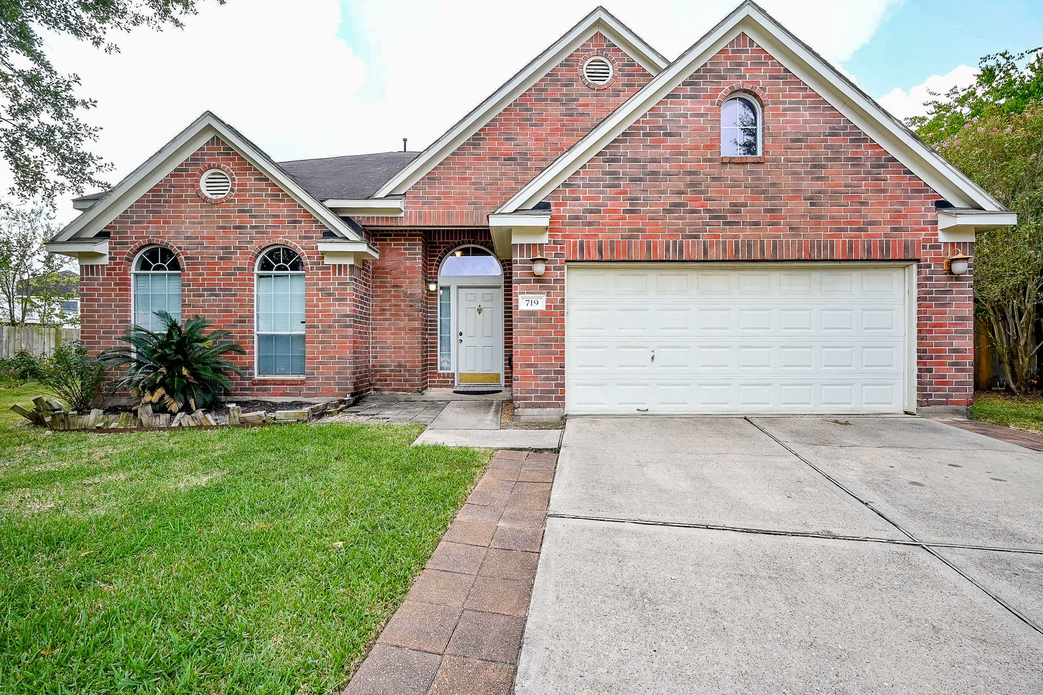 719 Winter Pines Court Spring, TX 77373 - Photo 1 of 20 a front view of a house with a yard and garage