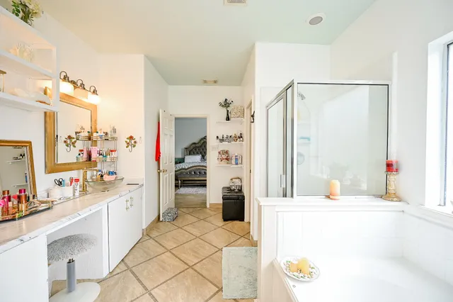 a bathroom with a sink mirror and a shower