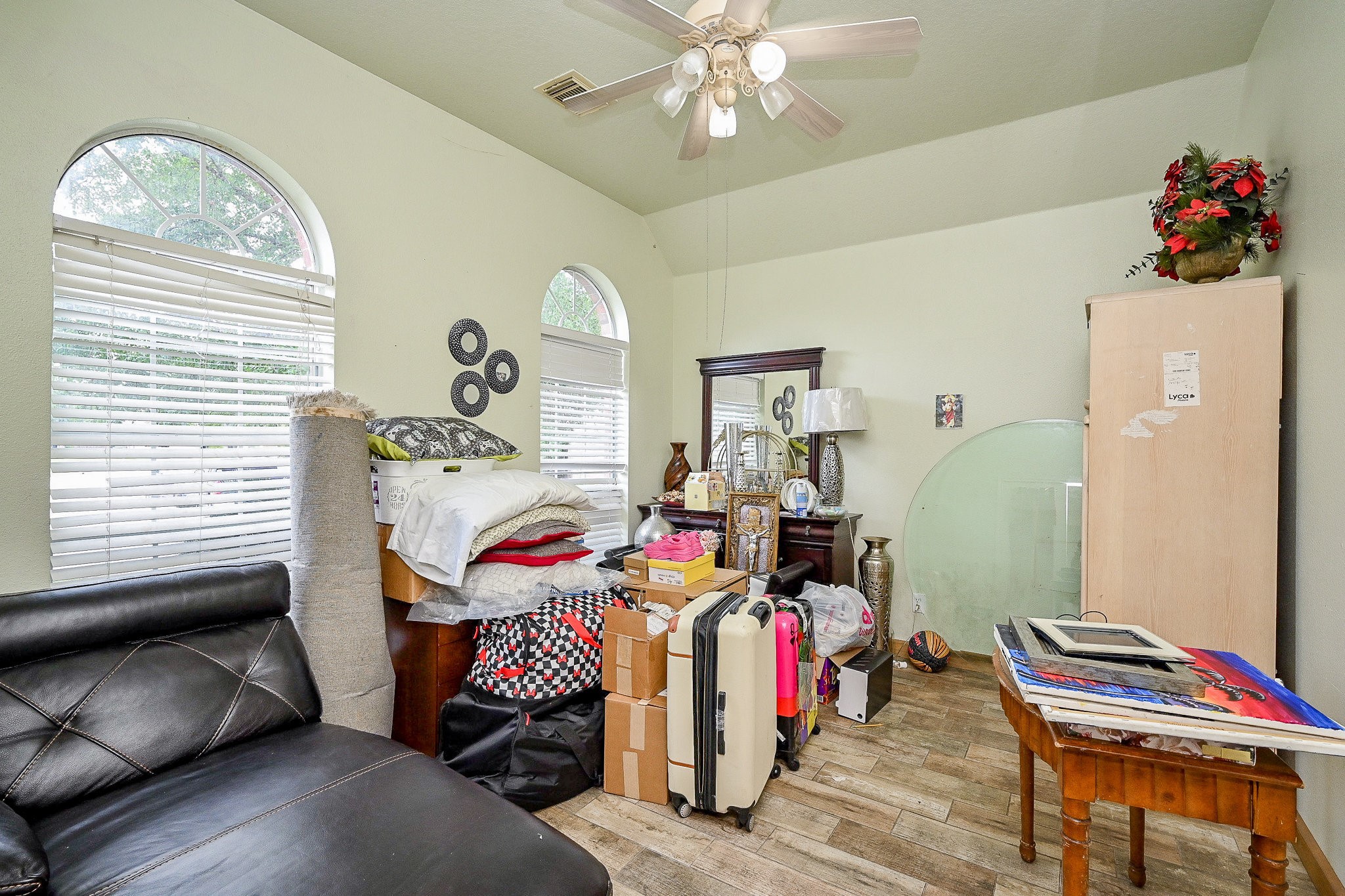 719 Winter Pines Court Spring, TX 77373 - Photo 16 of 20 a bedroom with a bed and a chandelier