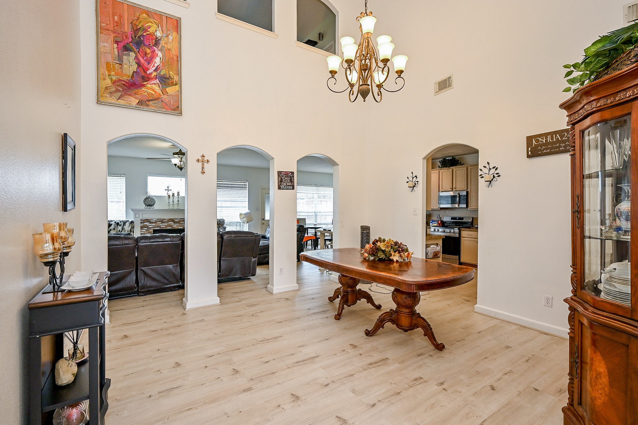 719 Winter Pines Court Spring, TX 77373 - Photo 4 of 20 a living room with furniture a dining table and paintings on the wall