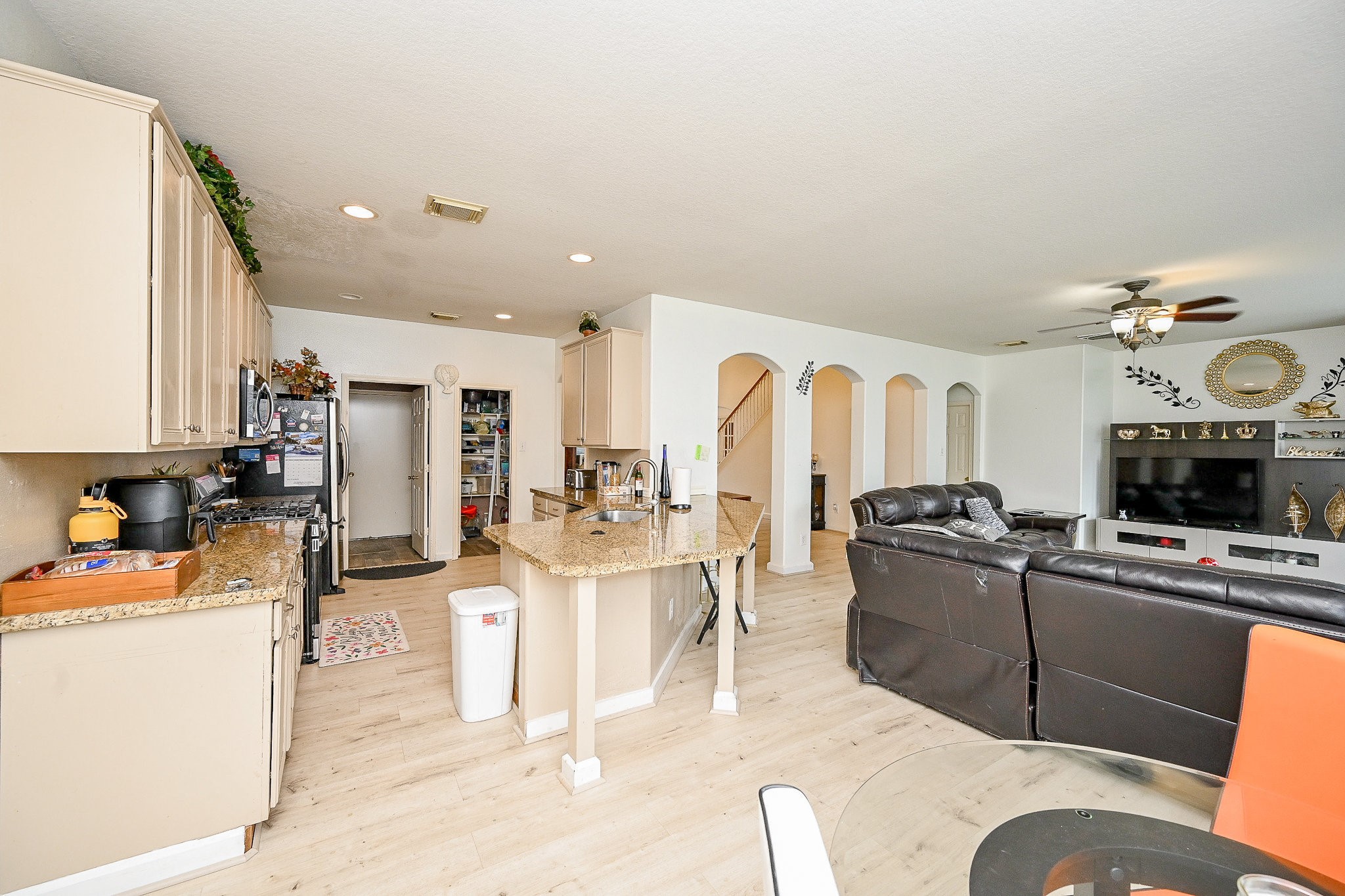 719 Winter Pines Court Spring, TX 77373 - Photo 8 of 20 a living room with furniture a flat screen tv and kitchen view