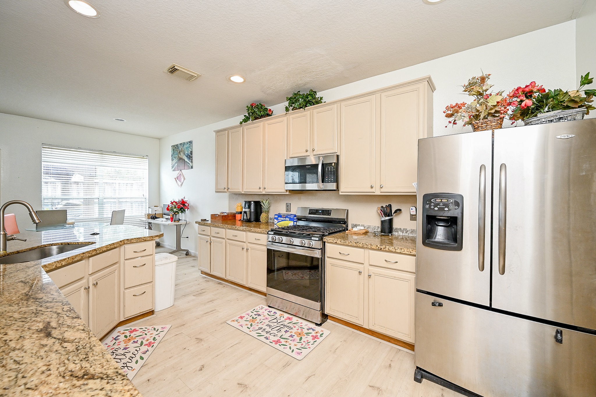 719 Winter Pines Court Spring, TX 77373 - Photo 9 of 20 a kitchen with white cabinets and white appliances