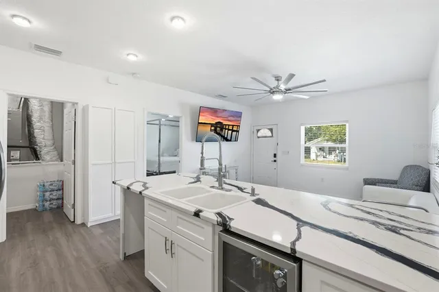 a room with a sink and a ceiling fan