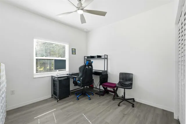 a view of a workspace with furniture and a window