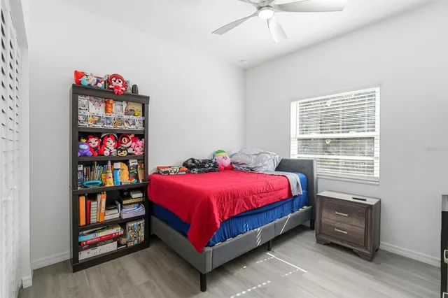 a spacious bedroom with a bed and a window