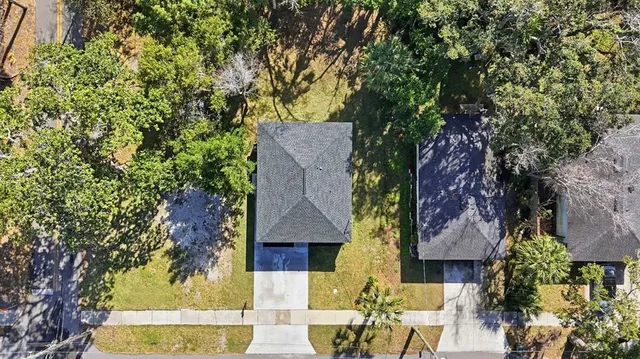 an aerial view of residential houses with outdoor space