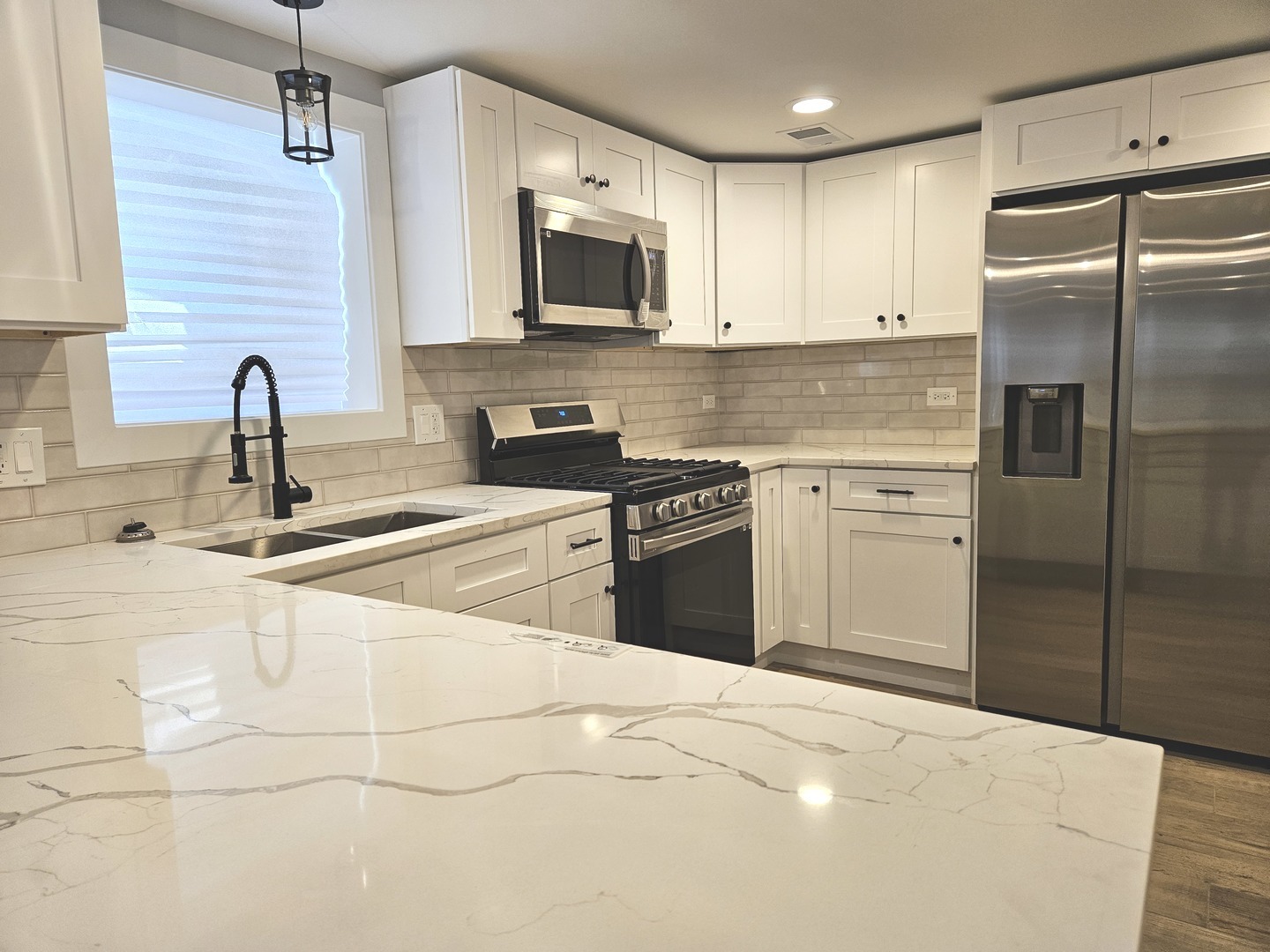 2828 Ridgeland Avenue, Unit 1 Berwyn, IL 60402 - Photo 2 of 9 a kitchen with stainless steel appliances granite countertop a sink and a stove