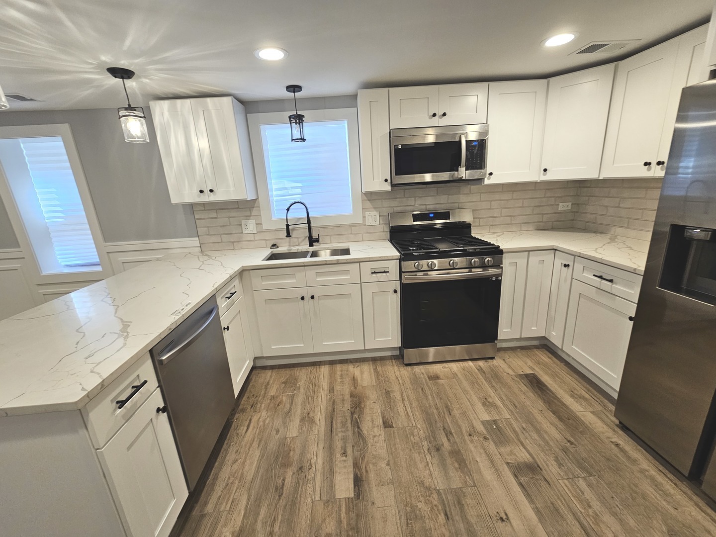 2828 Ridgeland Avenue, Unit 1 Berwyn, IL 60402 - Photo 3 of 9 a kitchen with a stove a sink and a microwave