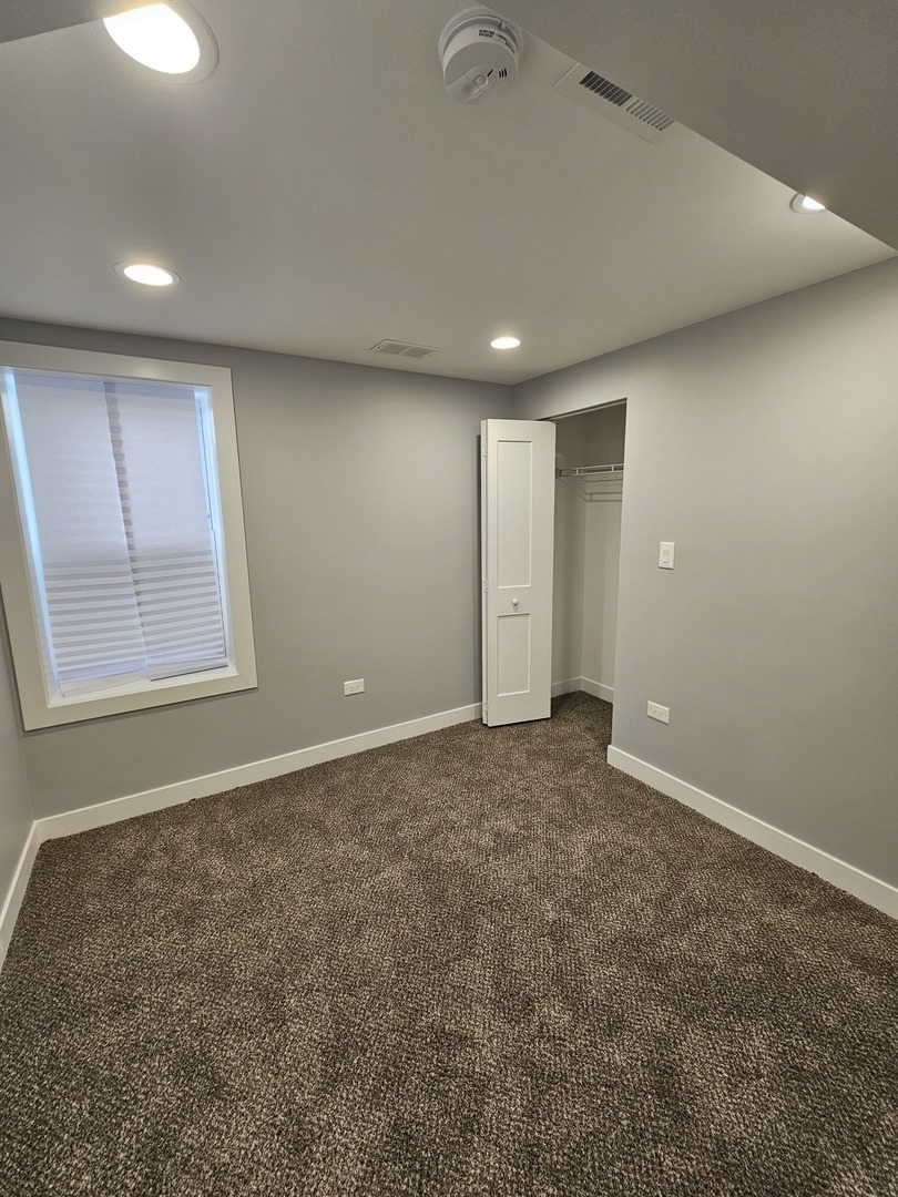 2828 Ridgeland Avenue, Unit 1 Berwyn, IL 60402 - Photo 7 of 9 an empty room with windows