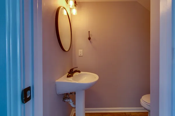 a bathroom with a sink toilet and mirror