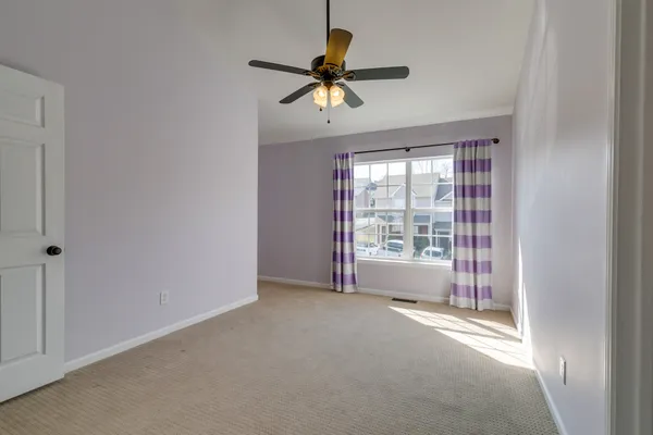 a view of livingroom with window and a ceiling fan