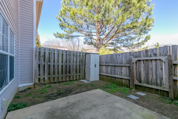 a view of a backyard with wooden fence