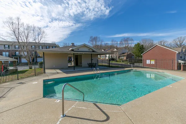 an outdoor view of house with swimming pool and yard