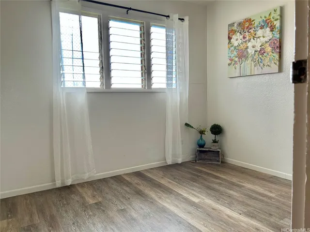 a view of room with wooden floor and lounge chair