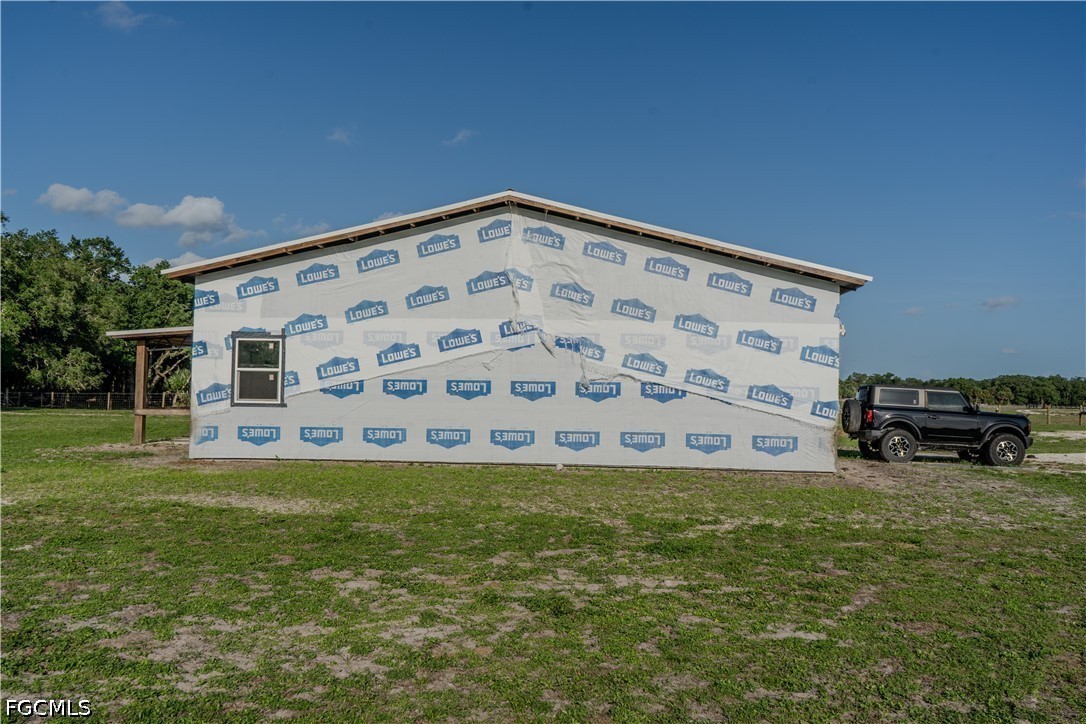 595 Norris Road LaBelle, FL 33935 - Photo 11 of 22 a view of a big room with a big yard and plants