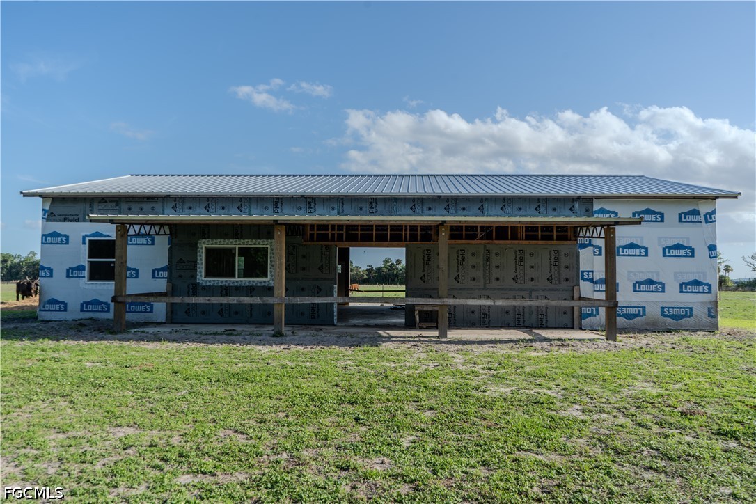 595 Norris Road LaBelle, FL 33935 - Photo 13 of 22 a view of house with backyard and a garden