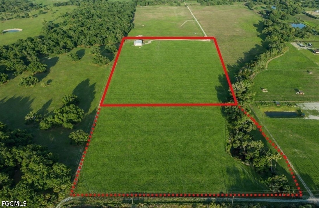 595 Norris Road LaBelle, FL 33935 - Photo 3 of 22 a view of a tennis ground with large trees