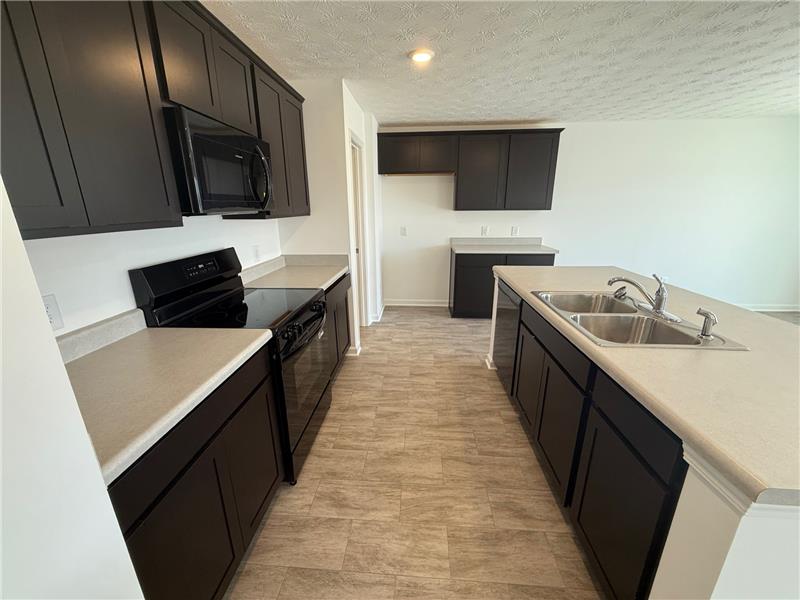 4005 Chakeres Avenue Springfield, OH 45505 - Photo 7 of 19 This kitchen offers ample counter space and modern appliances for culinary pursuits.
