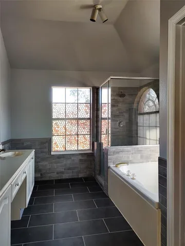 a bathroom with a bathtub and a sink