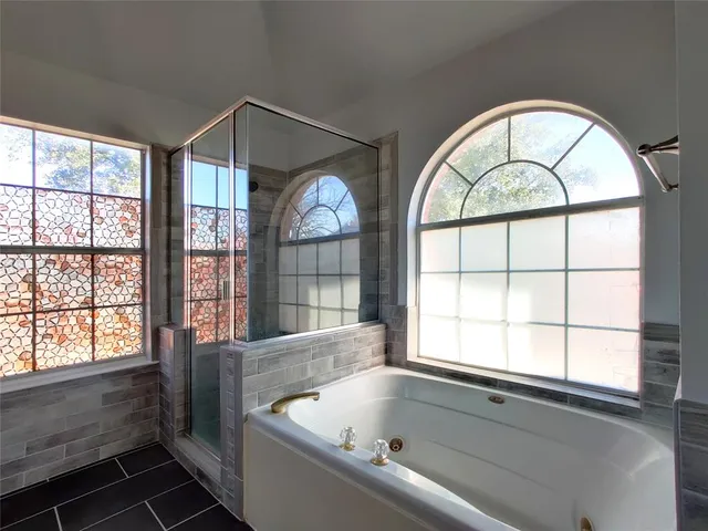 a bathroom with a bathtub and a shower