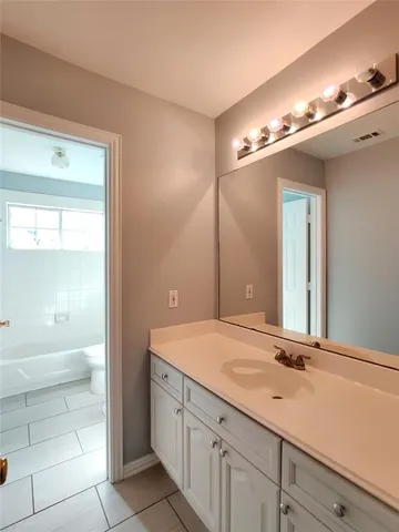 a bathroom with a sink a vanity and a mirror