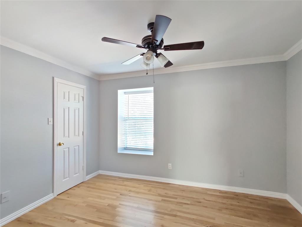 1200 St Regis Drive Irving, TX 75038 - Photo 17 of 17 an empty room with wooden floor chandelier fan and windows