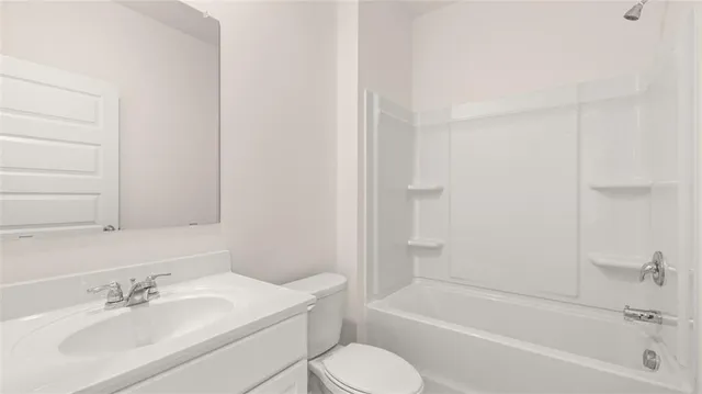 a view of empty room with wooden floor and window