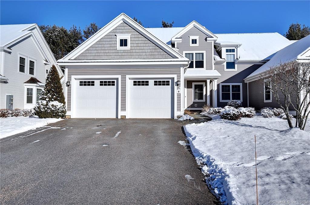 a view of a white house next to a road