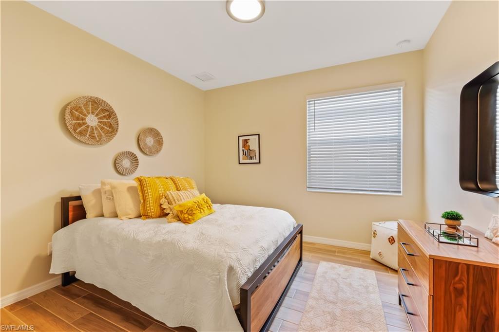 43080 Boardwalk Loop Babcock Ranch, FL 33982 - Photo 16 of 21 a bedroom with a bed and a window