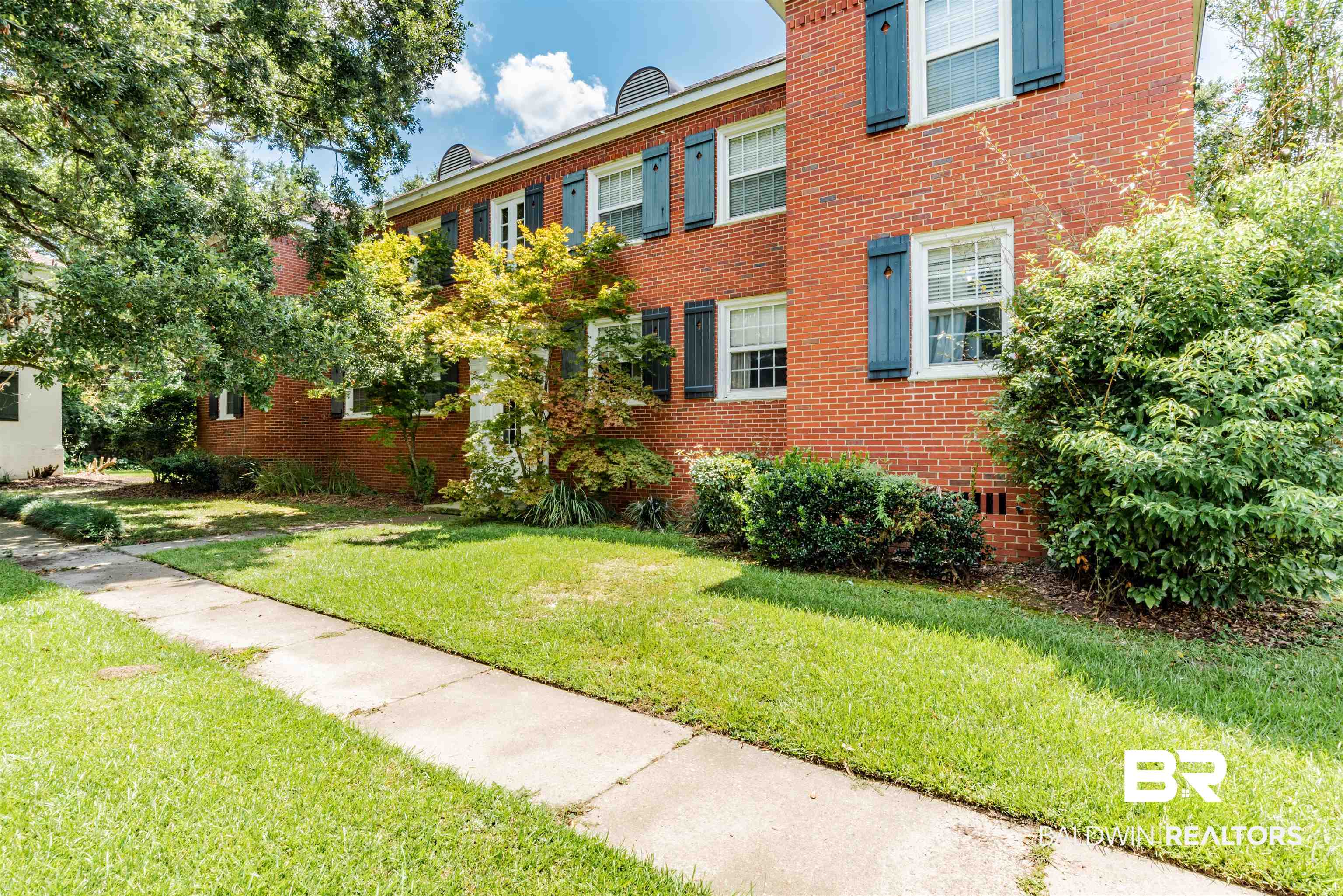 View of front of property with a front lawn and brick siding