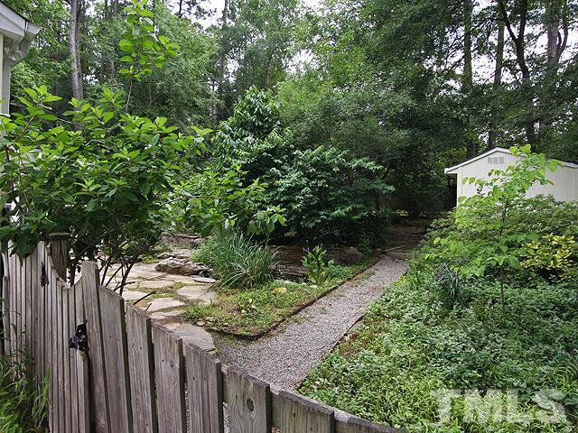 413 Tinkerbell Road Chapel Hill, NC 27517 - Photo 4 of 5 a wooden fence with trees in the background