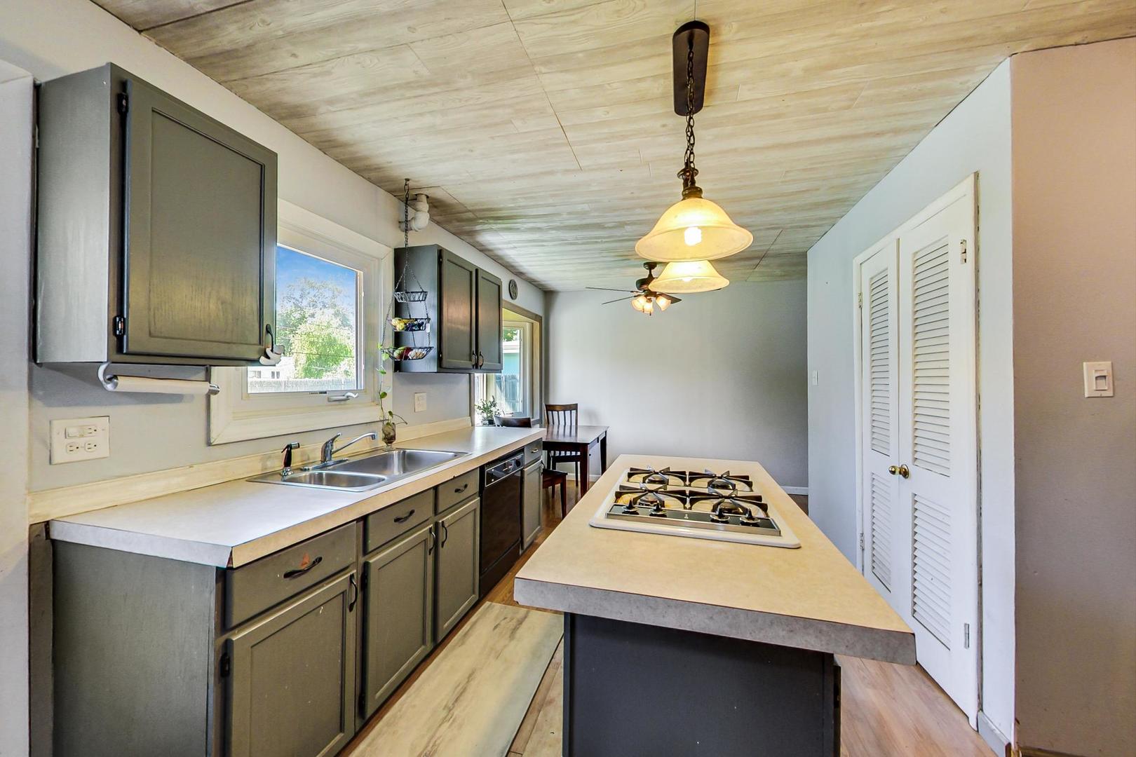 661 East Baldwin Road Palatine, IL 60074 - Photo 11 of 26 a kitchen with a sink stove and refrigerator