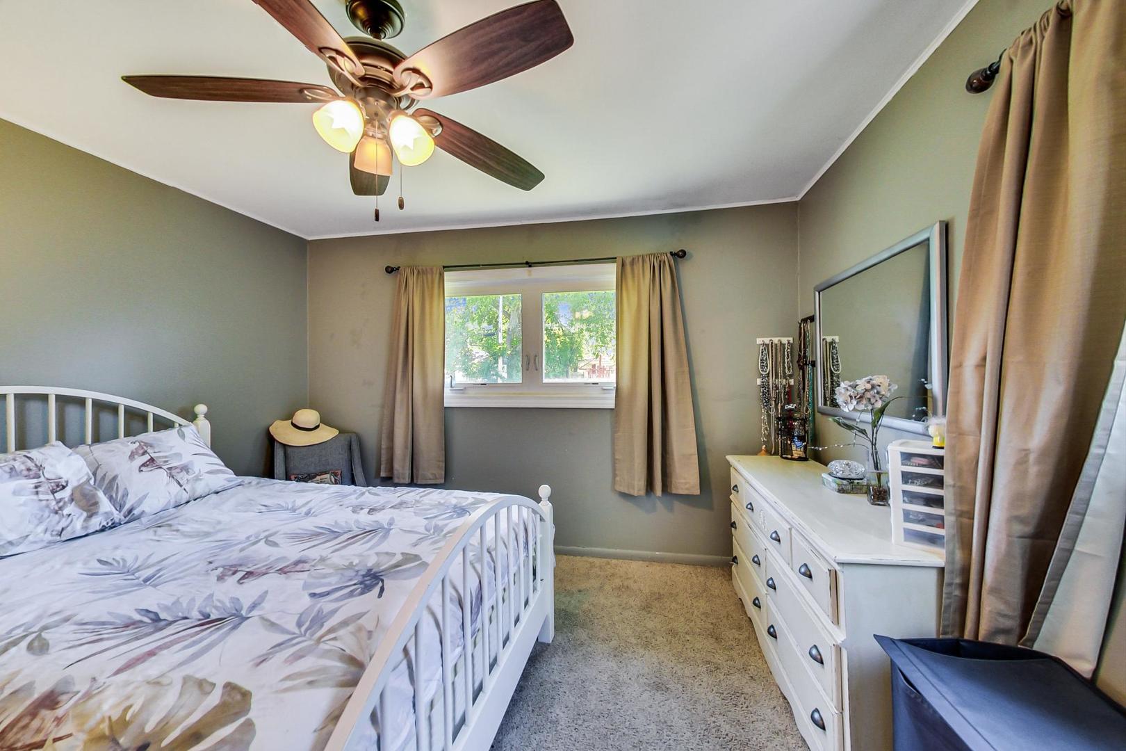 661 East Baldwin Road Palatine, IL 60074 - Photo 13 of 26 a bedroom with a bed dresser and a window