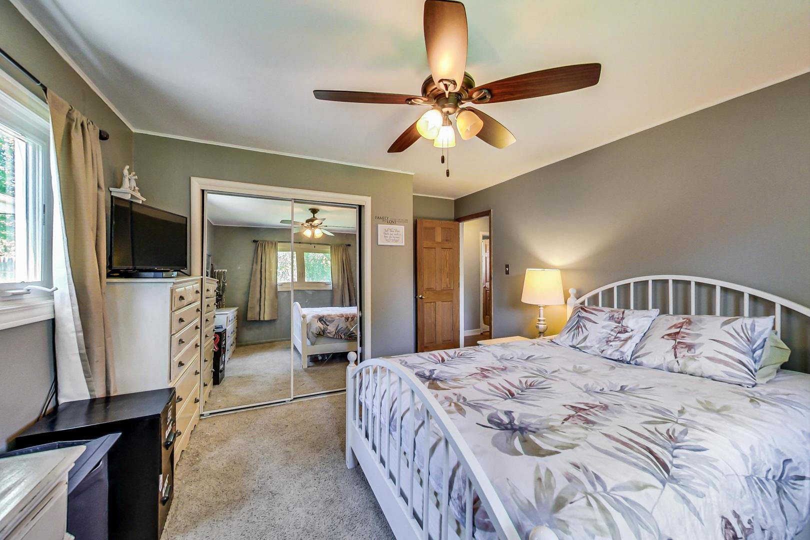 661 East Baldwin Road Palatine, IL 60074 - Photo 14 of 26 a bedroom with a bed and a flat screen tv