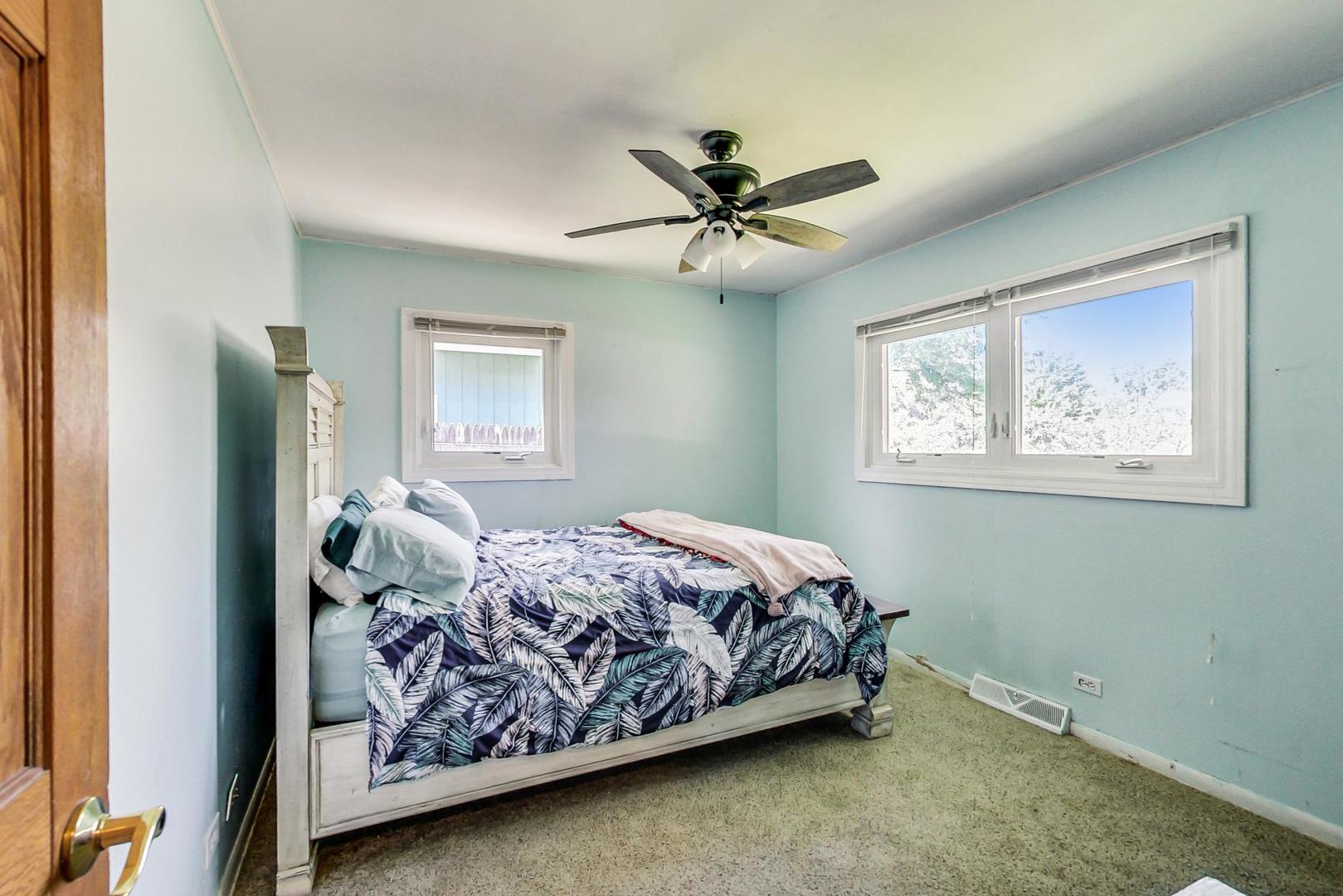 661 East Baldwin Road Palatine, IL 60074 - Photo 15 of 26 a bedroom with a bed and a window