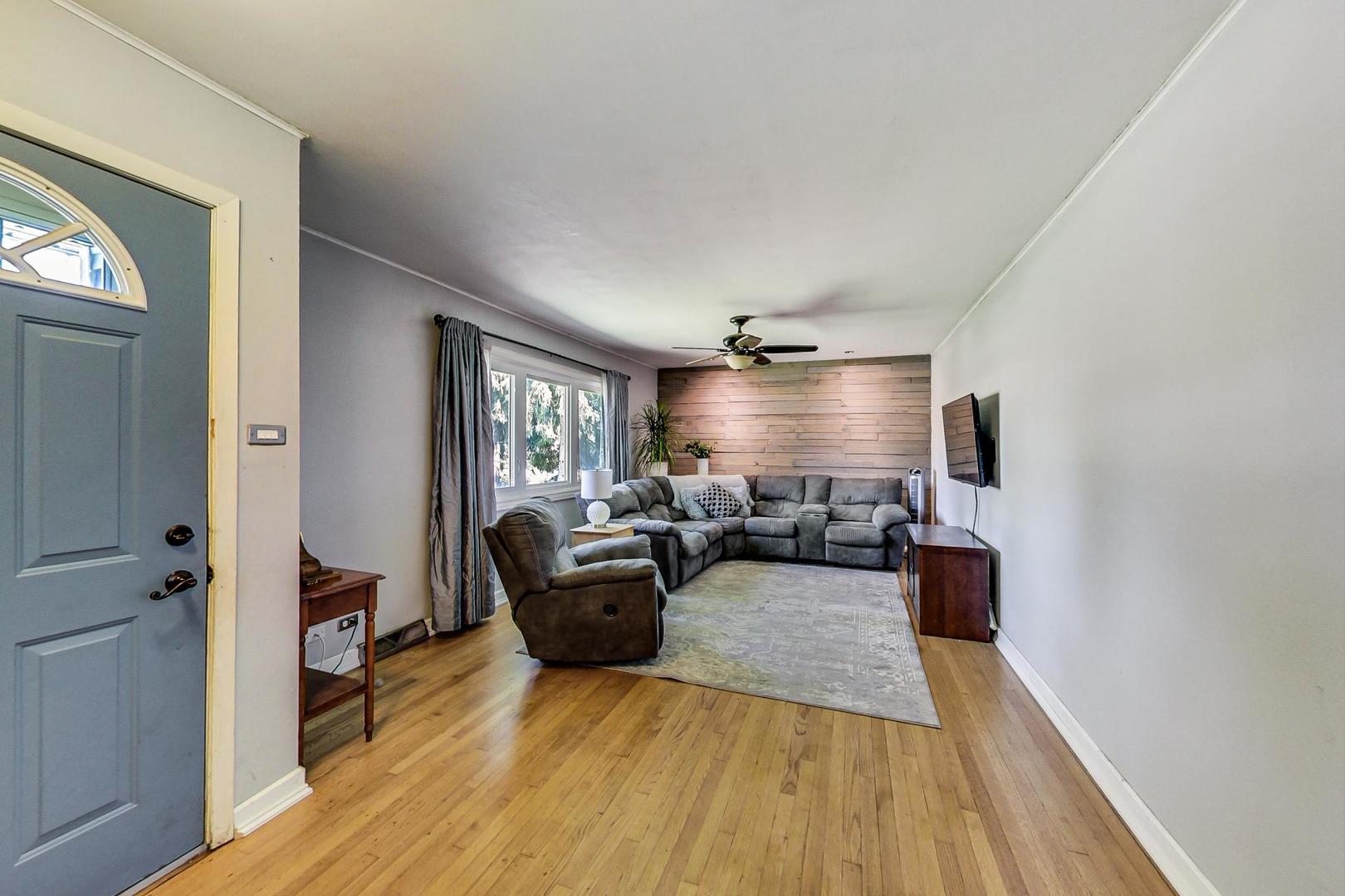 661 East Baldwin Road Palatine, IL 60074 - Photo 4 of 26 a living room with furniture and a wooden floor