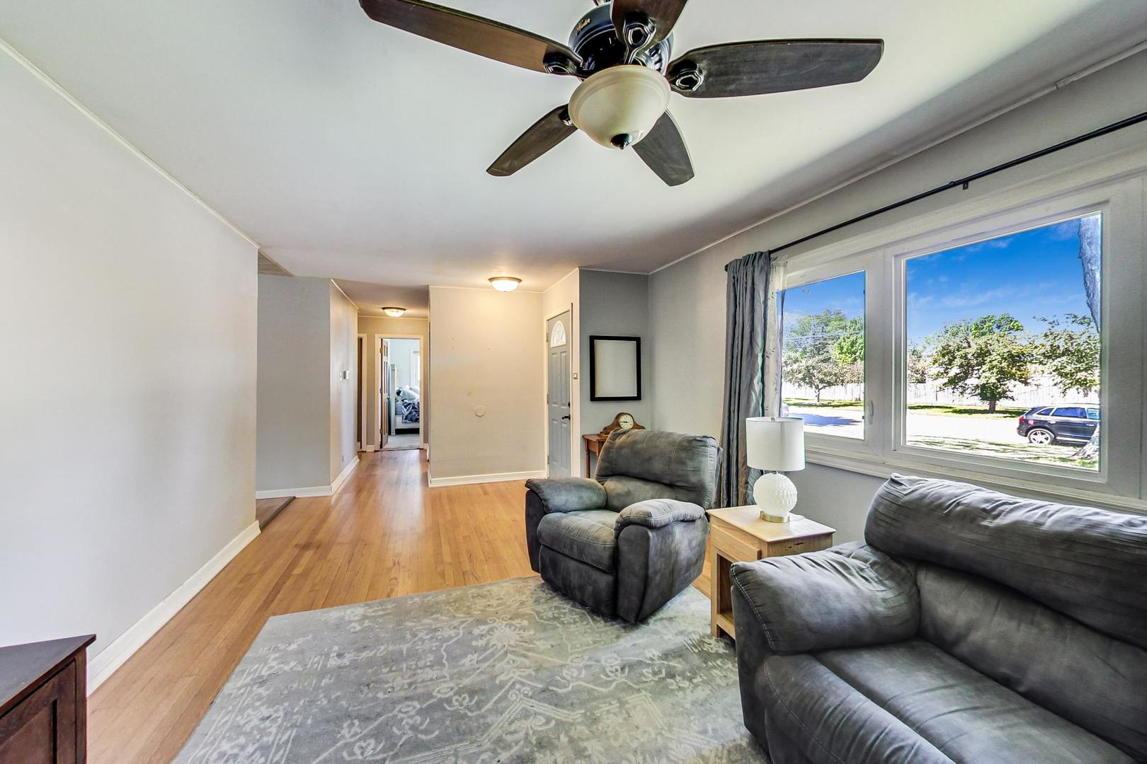 661 East Baldwin Road Palatine, IL 60074 - Photo 6 of 26 a living room with furniture and a large window