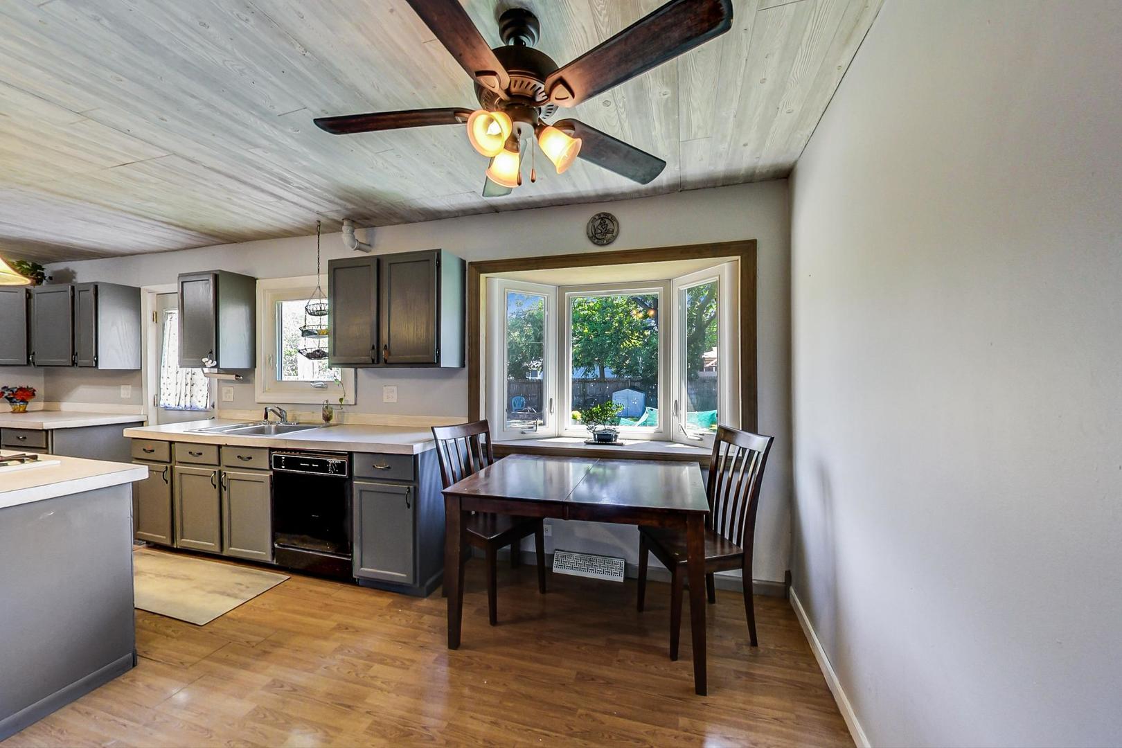 661 East Baldwin Road Palatine, IL 60074 - Photo 7 of 26 a view of a dining room with furniture window and wooden floor