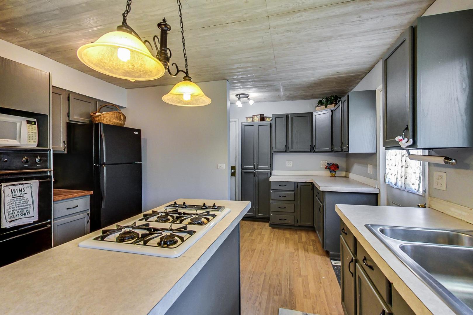 661 East Baldwin Road Palatine, IL 60074 - Photo 10 of 26 a kitchen with a sink stove and refrigerator