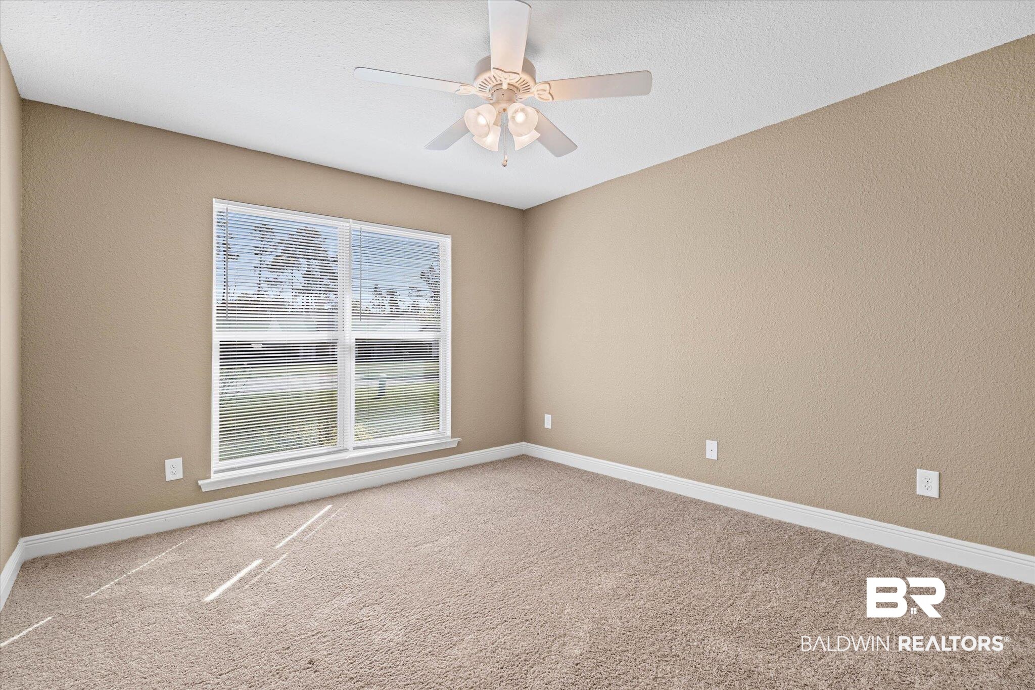 101 Washington Boulevard Foley, AL 36535 - Photo 20 of 32 Unfurnished room with light colored carpet, a textured wall, and ceiling fan