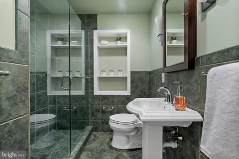 a bathroom with a sink toilet and shower