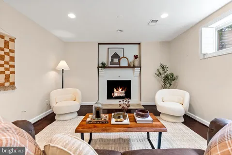 a living room with furniture a rug and a fireplace
