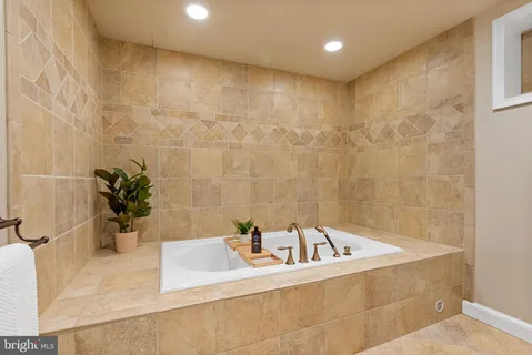 a bathroom with a bathtub and a sink